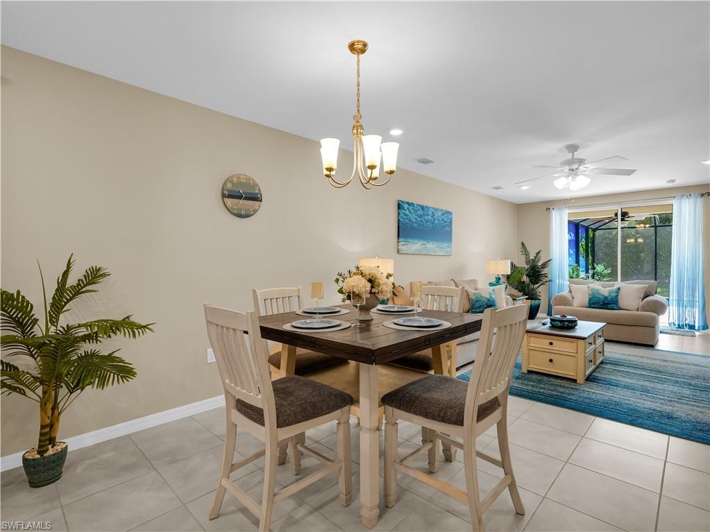 14695 Edgewater Circle Naples, FL 34114 - Photo 7 of 39 a view of a dining room with furniture window and wooden floor