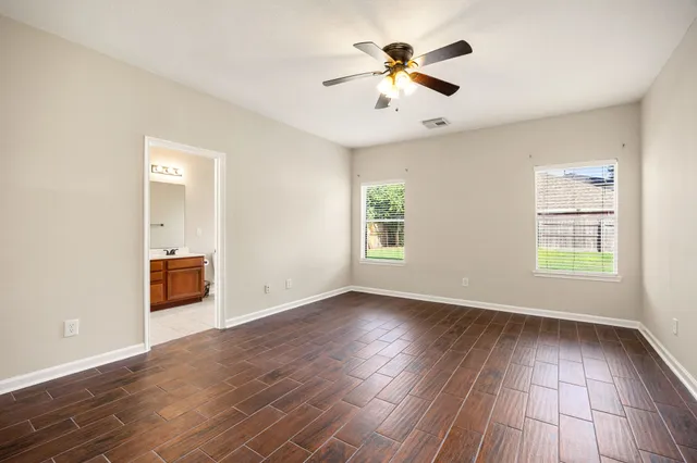 wooden floor in an empty room with a window