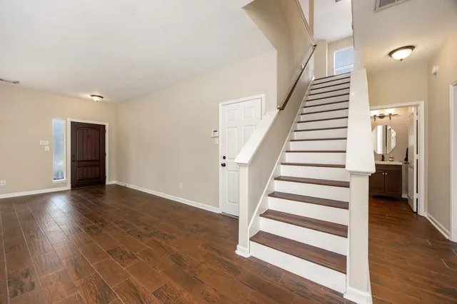 a view of a room with wooden floor and stairs