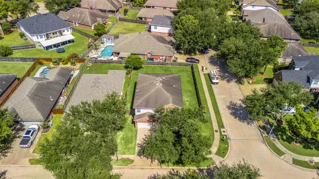 an aerial view of residential houses with outdoor space and street view