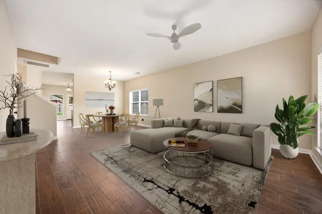 a living room with furniture and a wooden floor