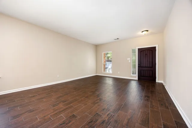 a view of wooden floor and windows in a room