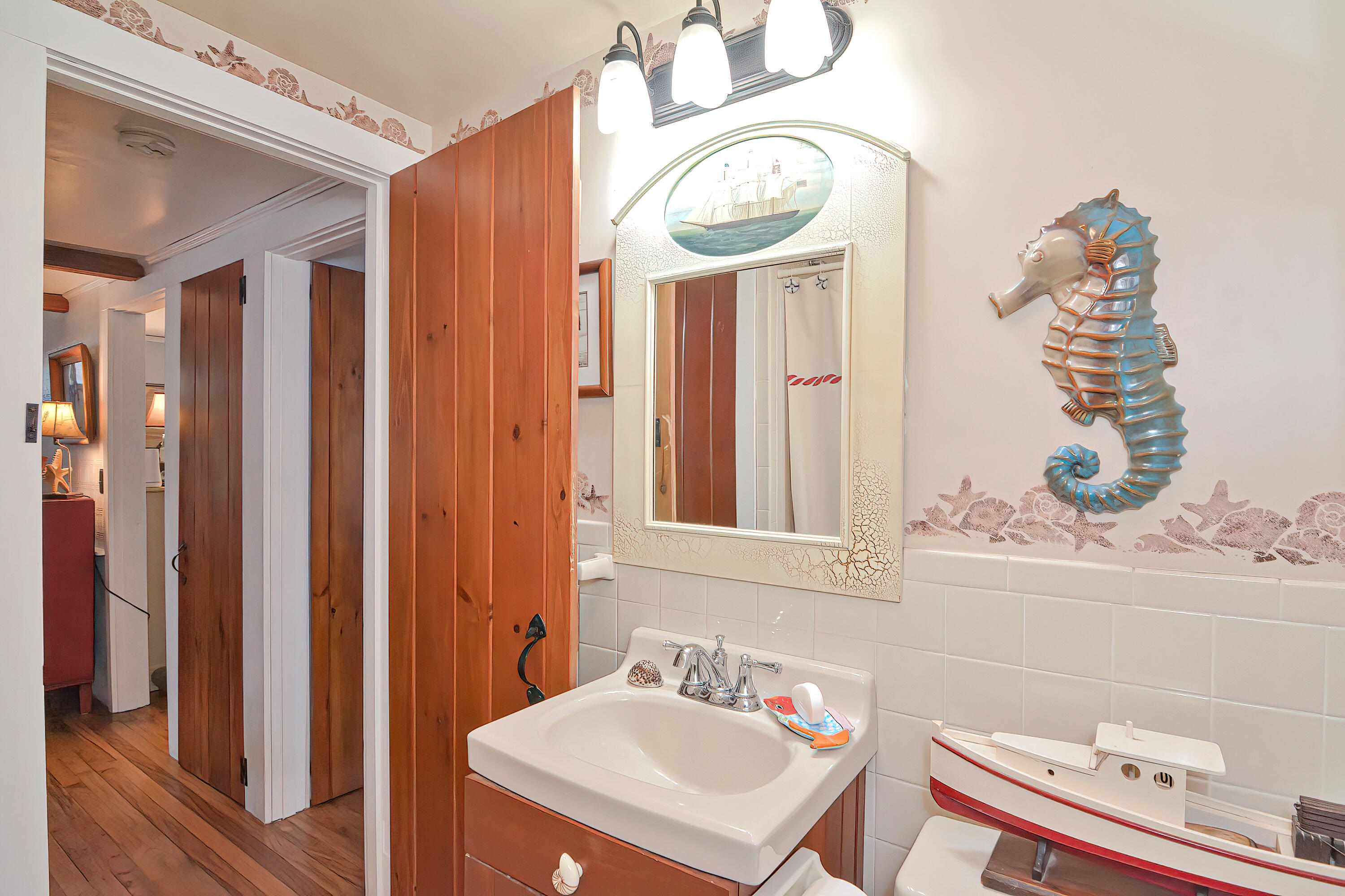 31 Susan Ruth Road Dennis Port, MA 02639 - Photo 18 of 27 a bathroom with a sink a mirror and a shower