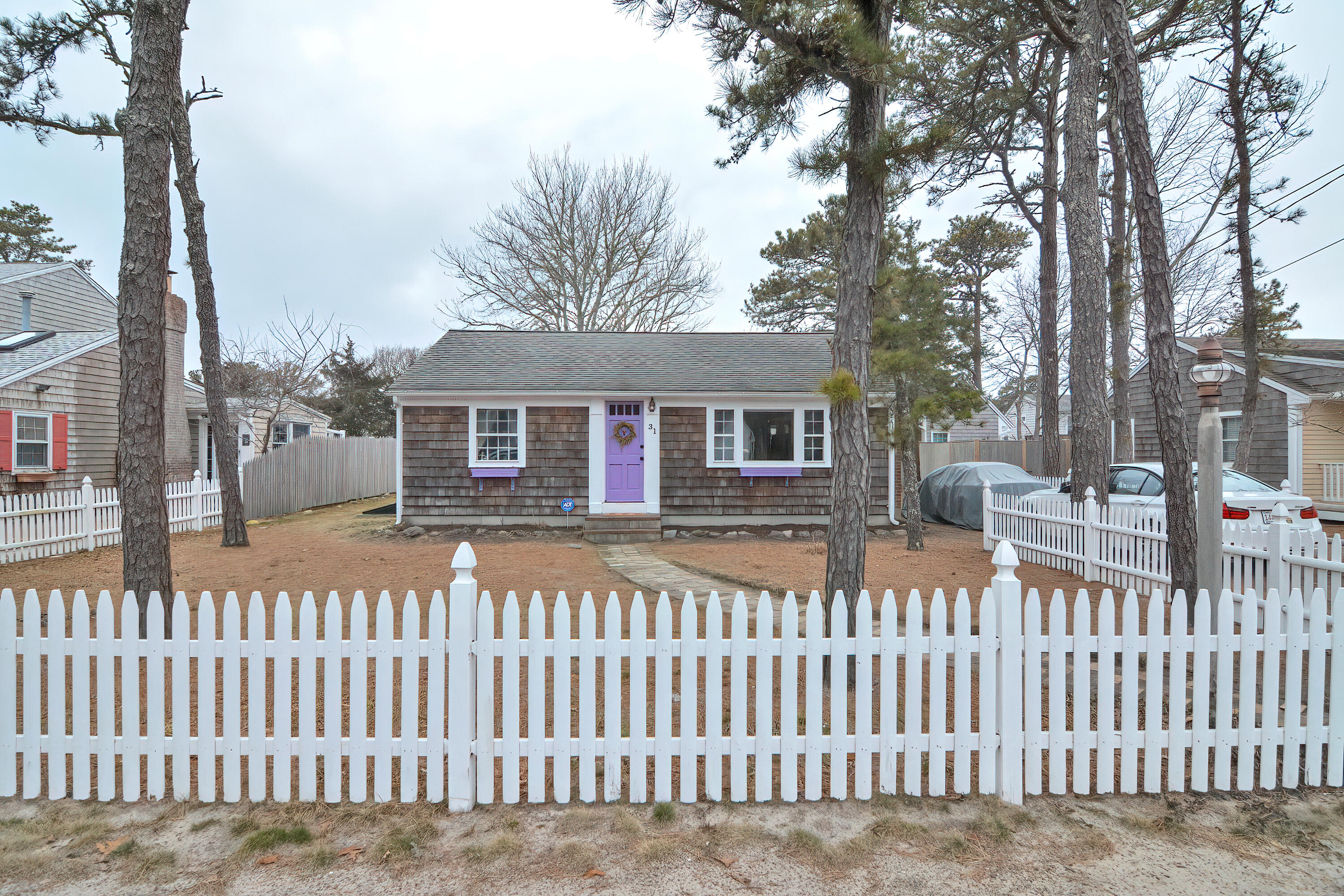 31 Susan Ruth Road Dennis Port, MA 02639 - Photo 21 of 27 a front view of a house with a wooden fence