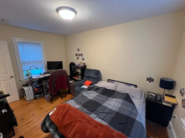 a bed sitting in a bedroom next to a window