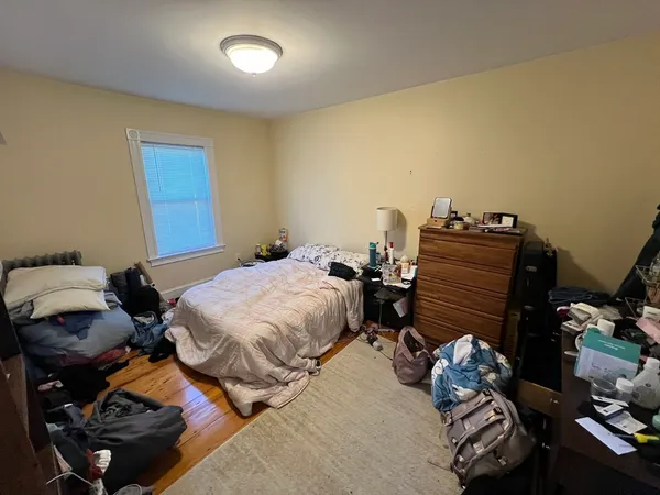 a bedroom with bed and a mirror