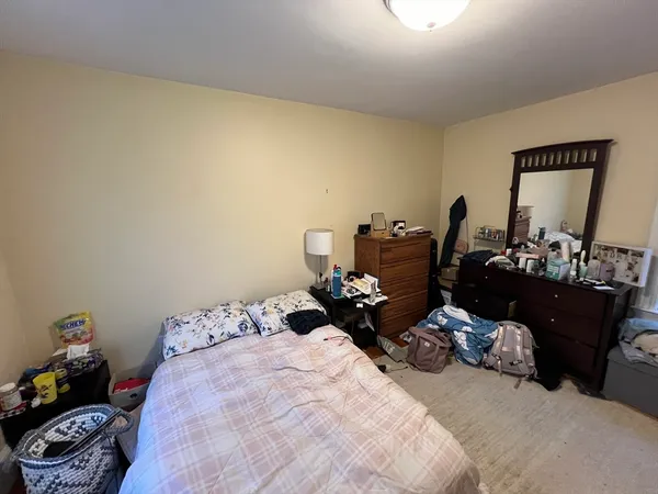 a bed room with a bed and a mirror