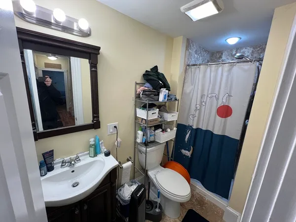 a bathroom with a sink toilet and shower