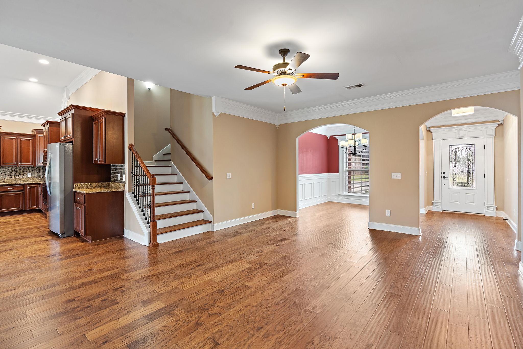 7670 Knobdate Road Smyrna, TN 37167 - Photo 7 of 29 a view of an empty room with wooden floor and staircase