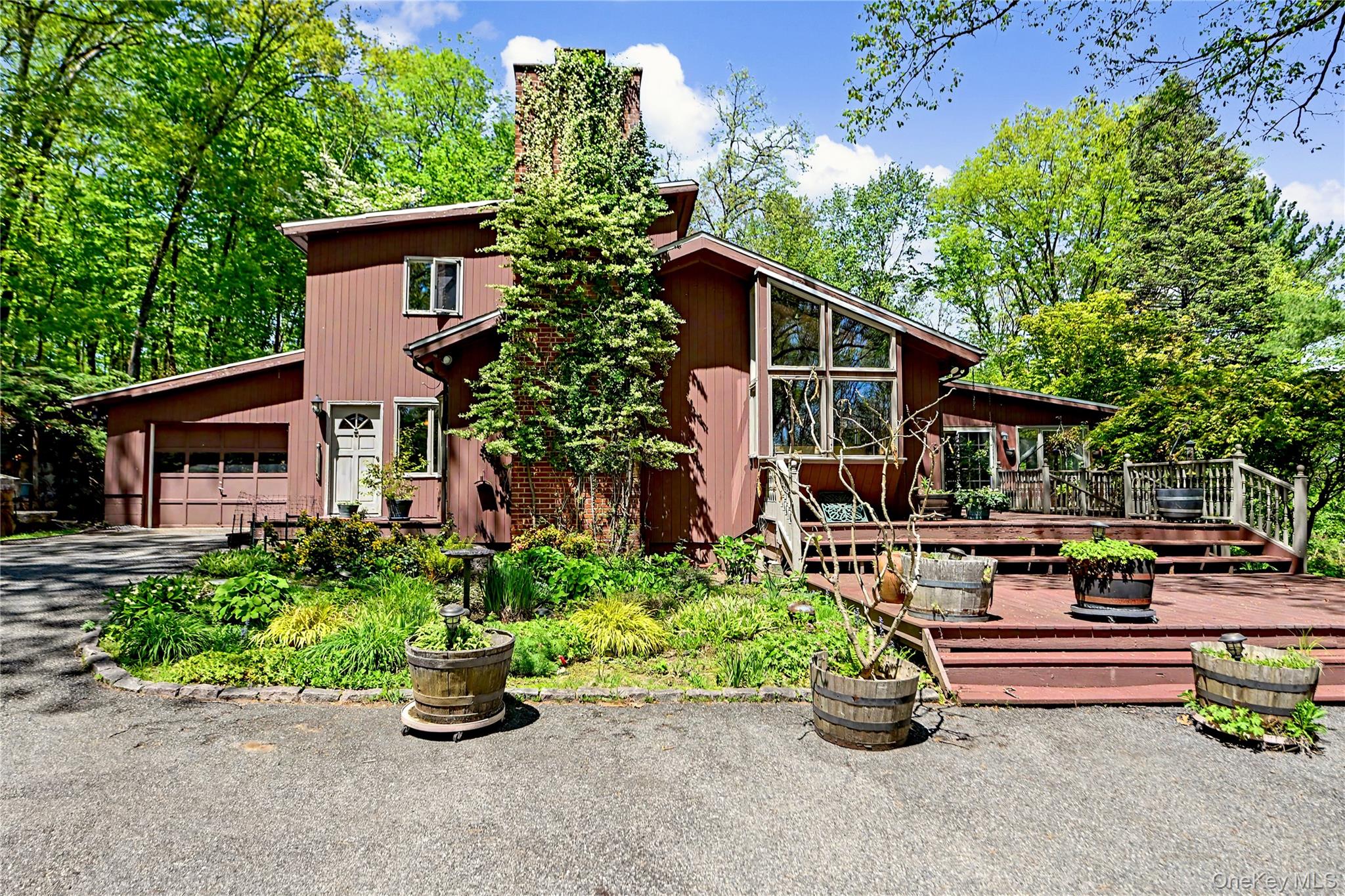 631 Croton Falls Road Carmel, NY 10512 - Photo 2 of 43 front view of a house with a garden
