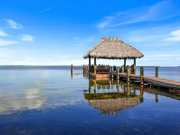 a view of a swimming pool with a table and chairs
