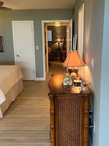 a bedroom with a bed and wall painting