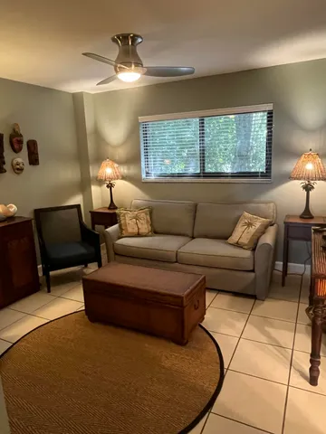 a dining room with furniture and a floor to ceiling window