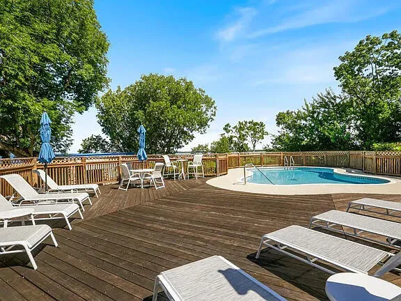 swimming pool view with a seating space