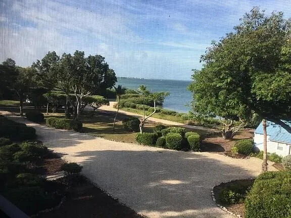 a view of a yard with cars parked