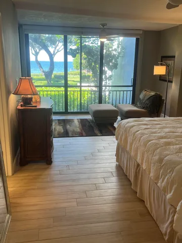 a large bed sitting in a bedroom next to a lamp