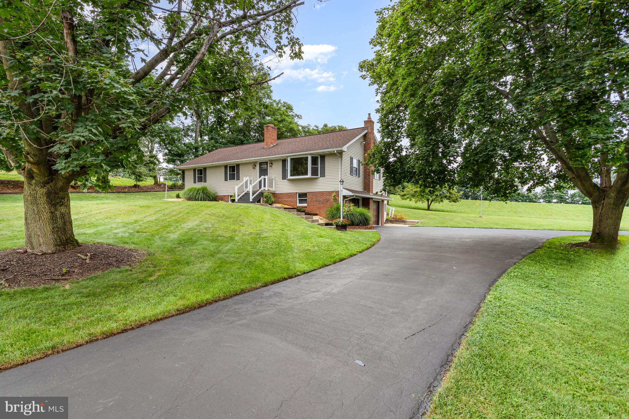 107 North Colebrook Road Manheim, PA 17545 - Photo 2 of 35 a view of a house with a big yard and large trees