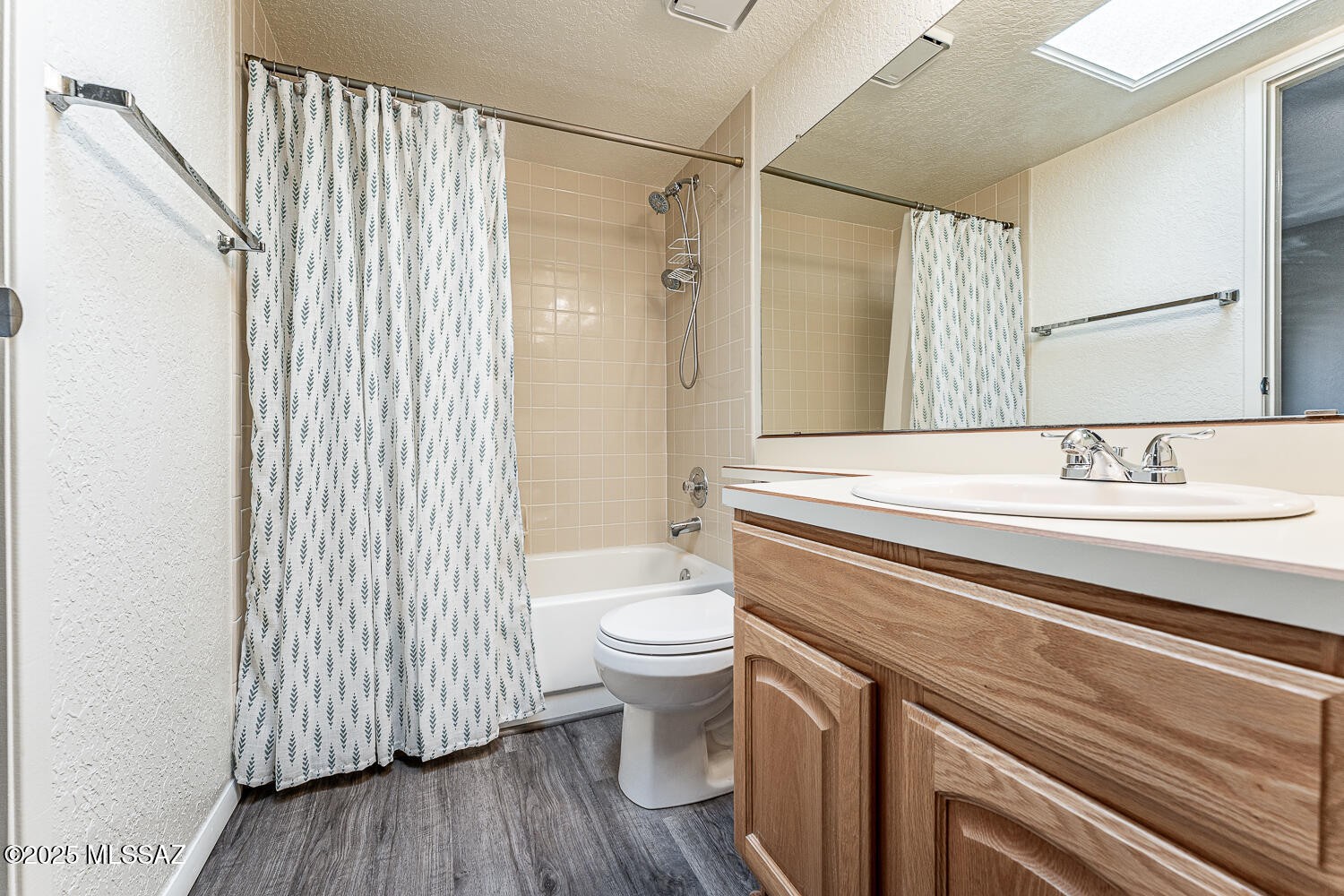 931 West Rio Guaymas Green Valley, AZ 85614 - Photo 32 of 39 a bathroom with a sink a toilet and shower curtain