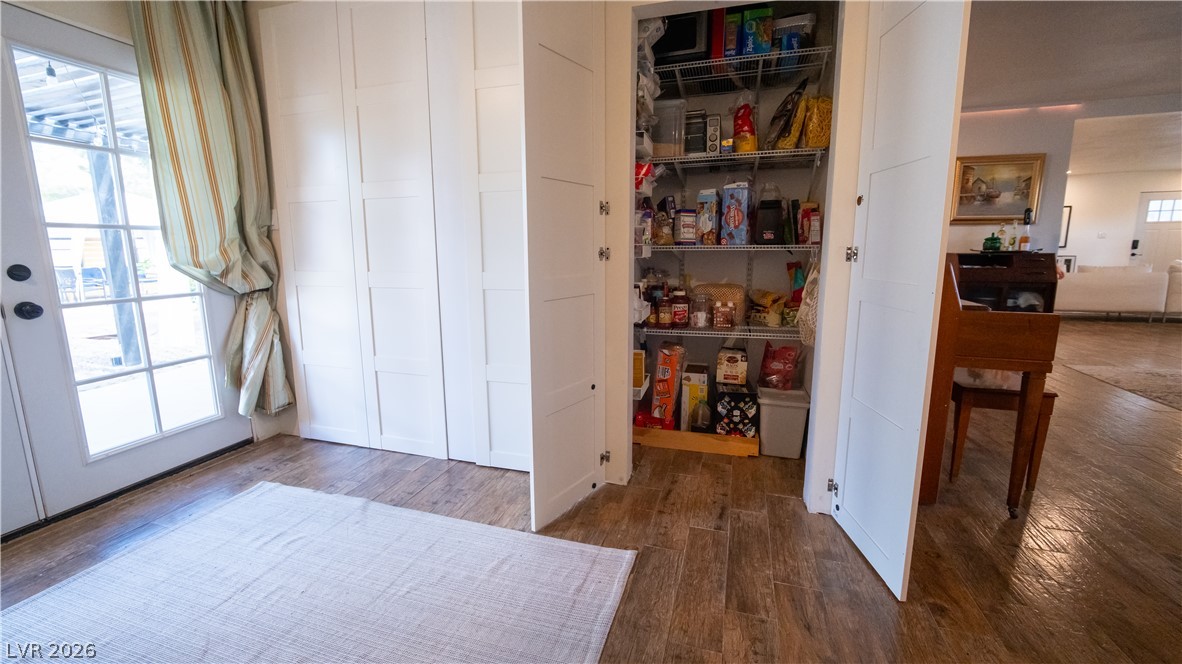 425 Blackridge Road Henderson, NV 89015 - Photo 21 of 31 Textured flooring leads past built-in storage closets and a walk-in pantry near the glass entry door.