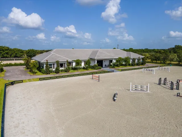 an aerial view of a house with a swimming pool and outdoor space