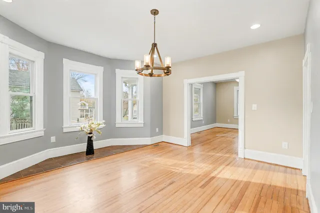 a view of a room with wooden floor and a window
