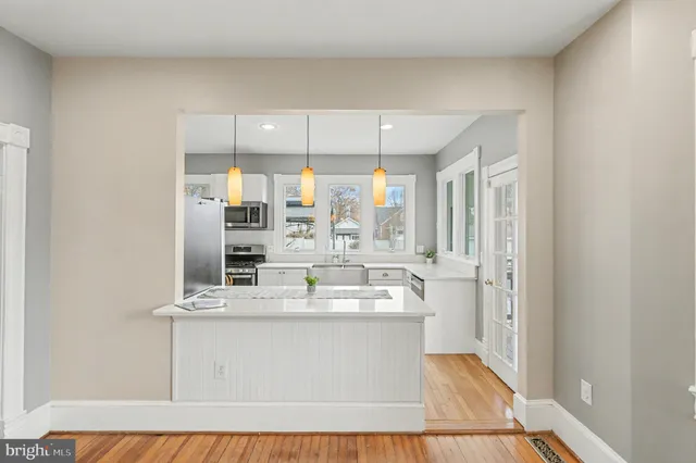 a kitchen with a stove a sink and a microwave