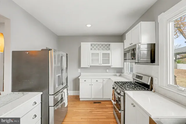 a kitchen with stainless steel appliances a stove microwave and sink