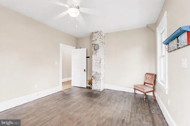 wooden floor in an empty room with a window