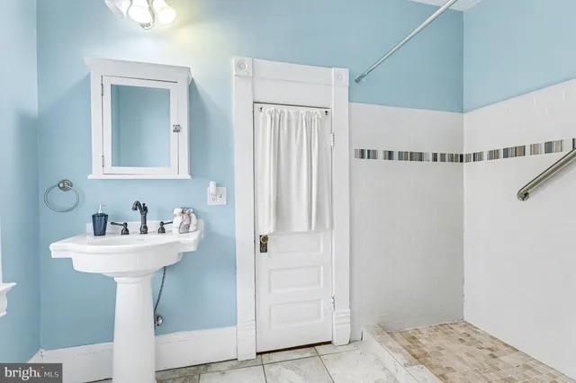 a bathroom with a sink mirror and toilet