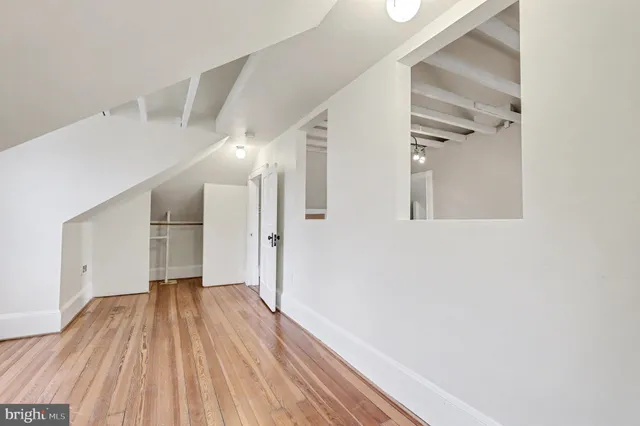 a view of a balcony with wooden floor and fence