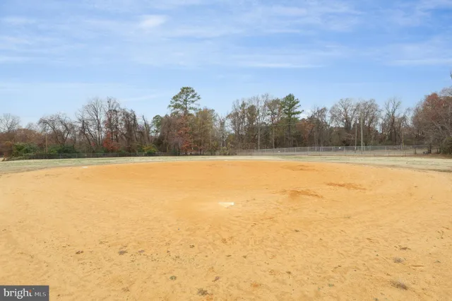 a street sign on a sidewalk next to a road