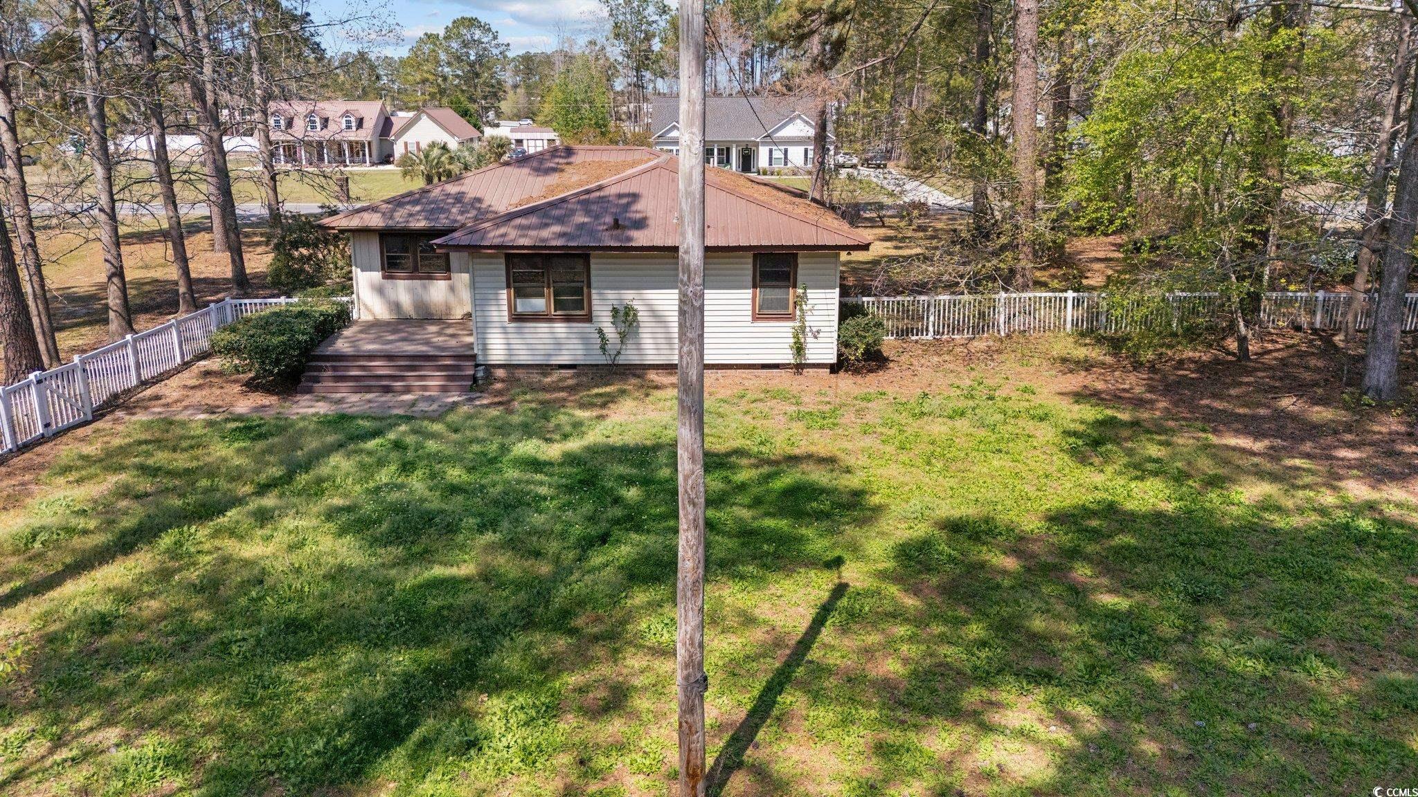 Exterior space featuring a fenced backyard, a lawn