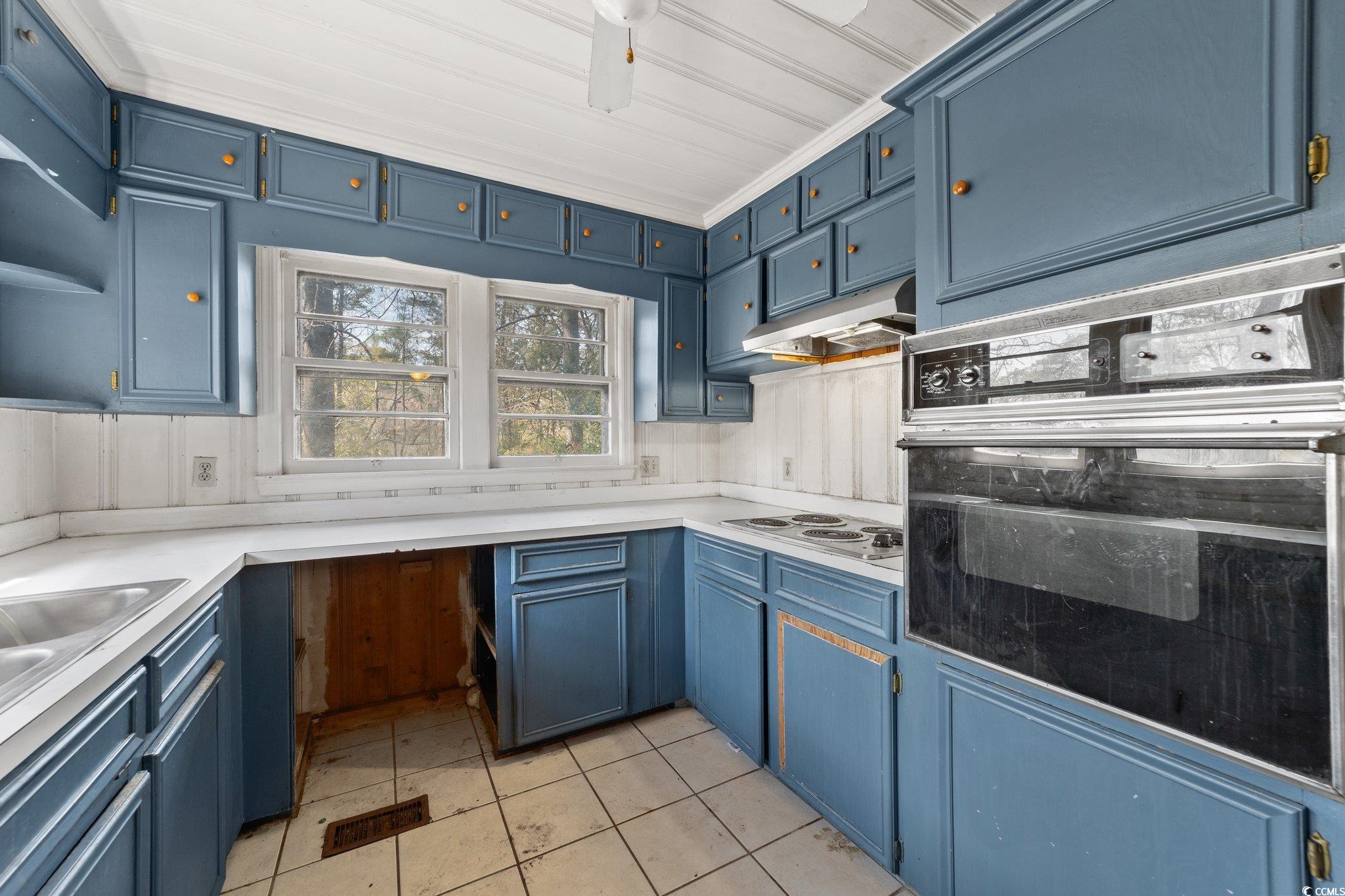 524 Allen Street Loris, SC 29569 - Photo 9 of 38 Kitchen with blue cabinetry, stainless steel elect
