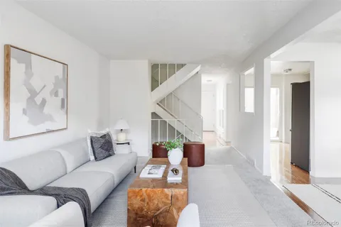 a living room with furniture and a potted plant