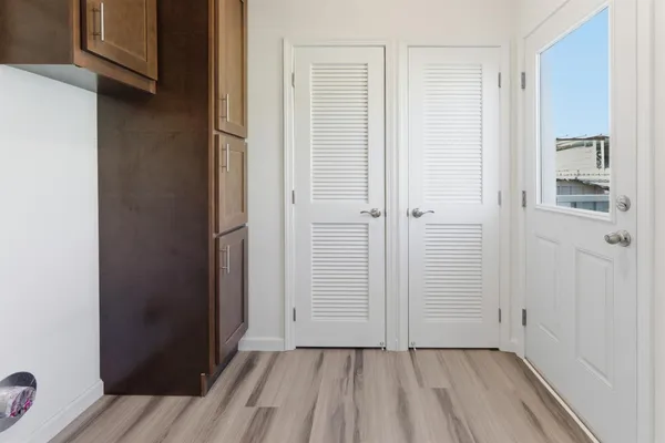 a view of a hallway with wooden floor