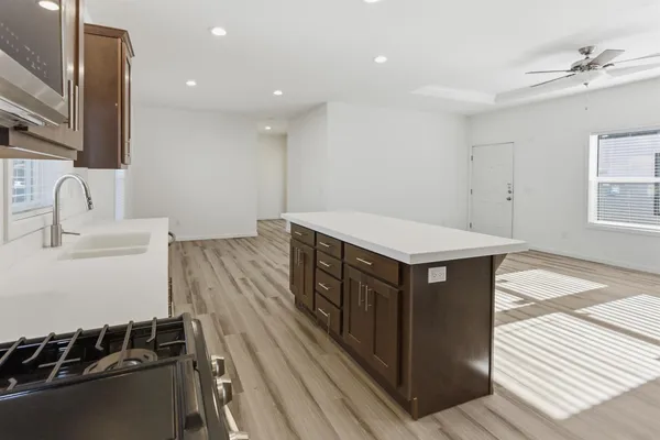 a kitchen with a sink stove and cabinets