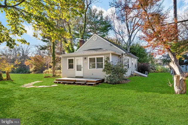 a front view of a house with a garden and yard