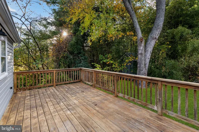 a balcony with wooden floor and trees