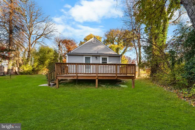 a view of a house with a yard and sitting area