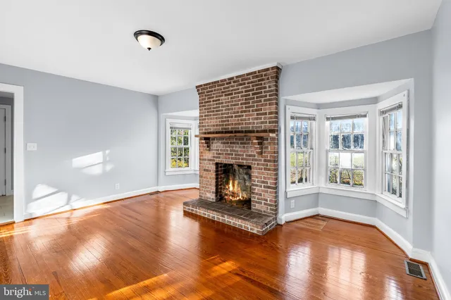 a living room with a fireplace with wooden floor