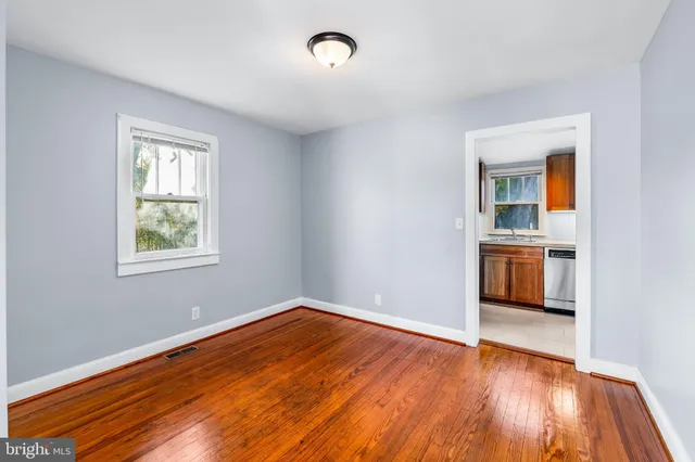 a view of a room with wooden floor and a window