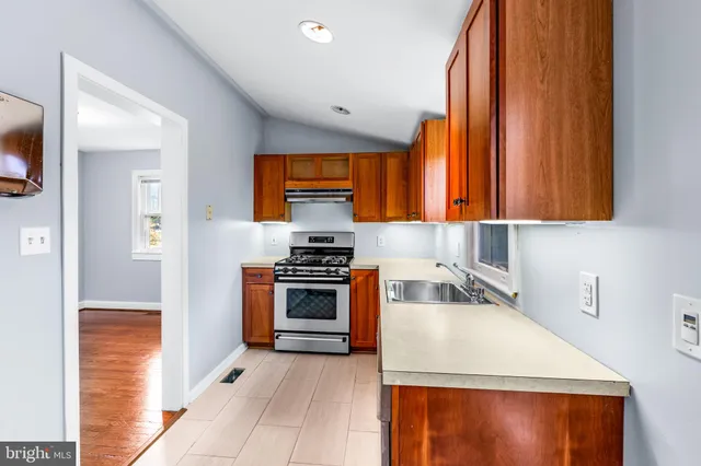 a kitchen with stainless steel appliances a stove a sink and a microwave