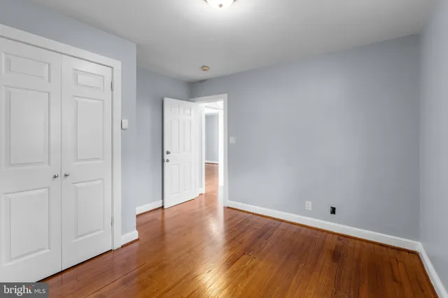 a view of an empty room and wooden floor