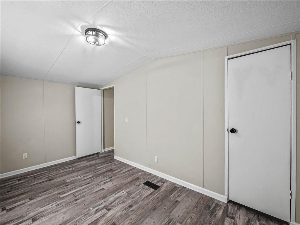 1458 Grant Mill Road Alto, GA 30510 - Photo 15 of 32 a view of an empty room with wooden floor