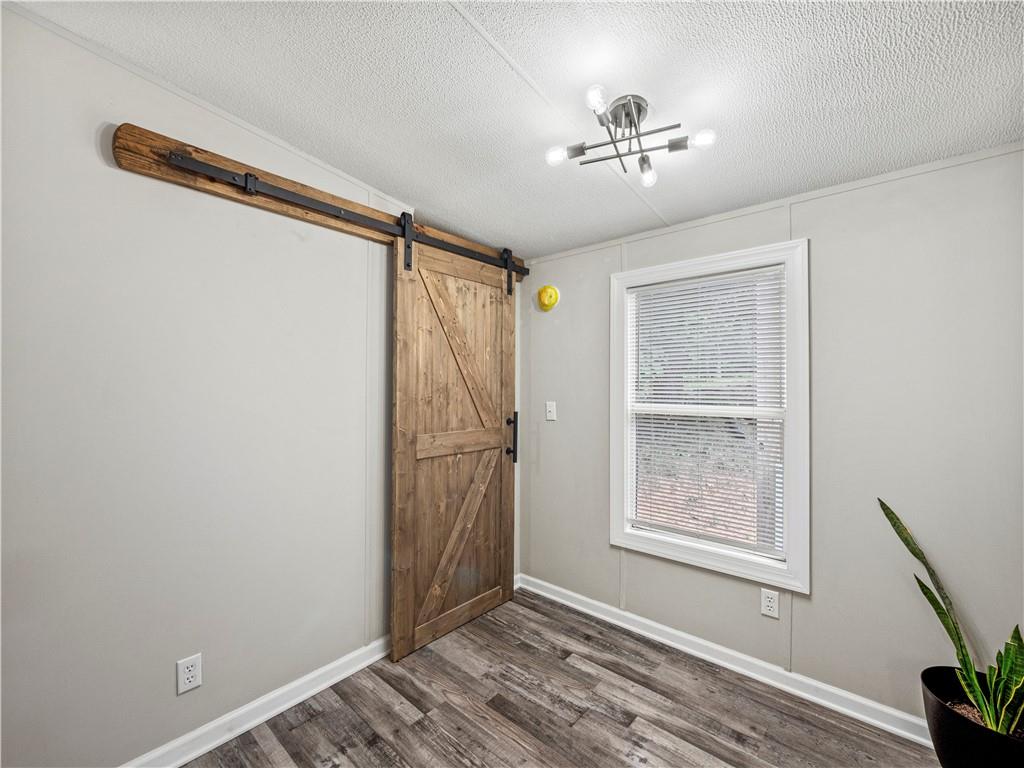 1458 Grant Mill Road Alto, GA 30510 - Photo 21 of 32 wooden floor in an empty room with a window
