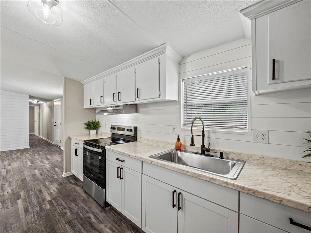 1458 Grant Mill Road Alto, GA 30510 - Photo 24 of 32 a kitchen with stainless steel appliances granite countertop a sink a stove and cabinets