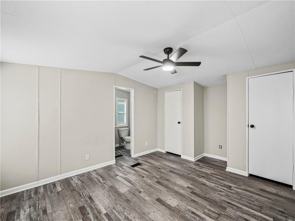 1458 Grant Mill Road Alto, GA 30510 - Photo 26 of 32 a view of a livingroom with wooden floor and a ceiling fan