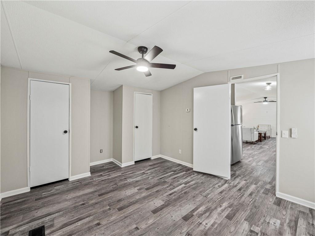 1458 Grant Mill Road Alto, GA 30510 - Photo 27 of 32 a view of a big room with wooden floor and a ceiling fan