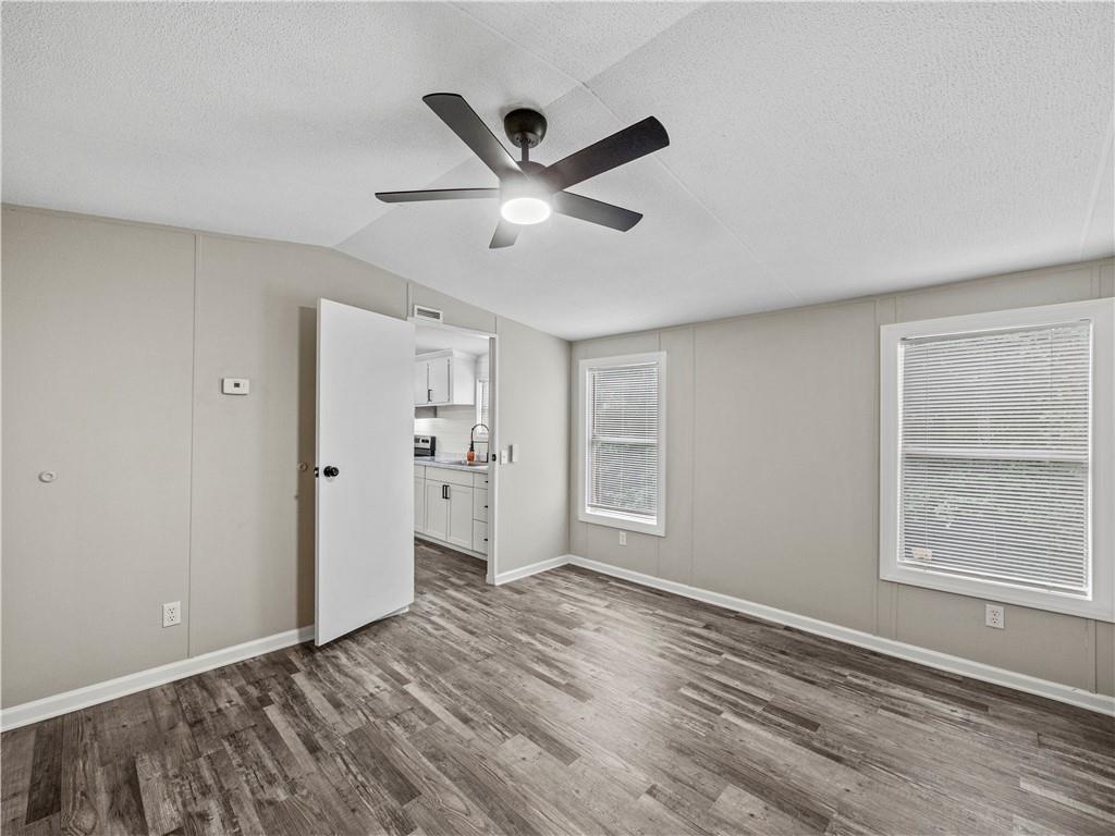 1458 Grant Mill Road Alto, GA 30510 - Photo 28 of 32 a view of an empty room with a window and wooden floor