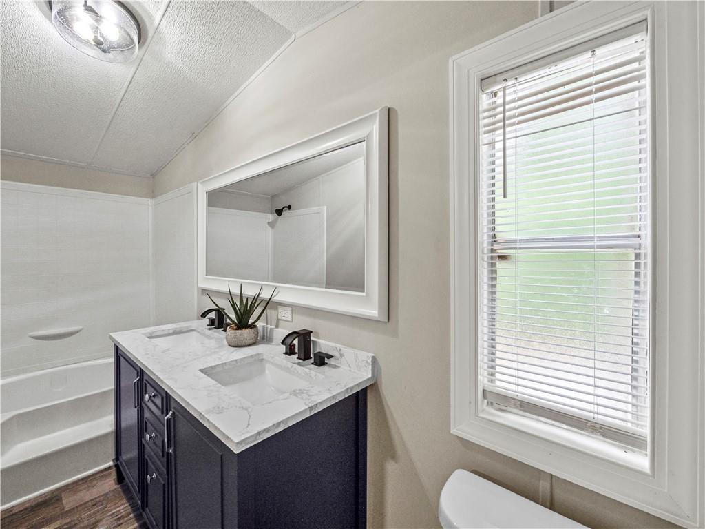 1458 Grant Mill Road Alto, GA 30510 - Photo 30 of 32 a bathroom with a granite countertop sink and a mirror